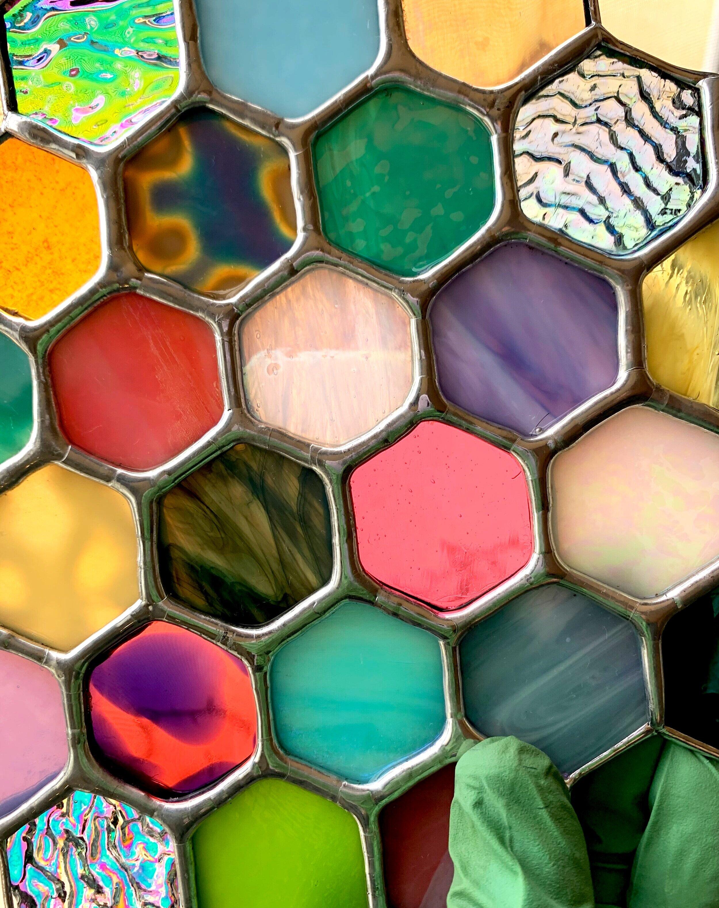 Stained glass hexagons with different colors and patterns coming together