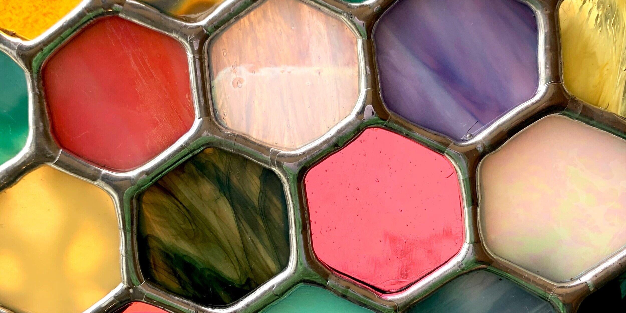 Stained glass hexagons with different colors and patterns coming together