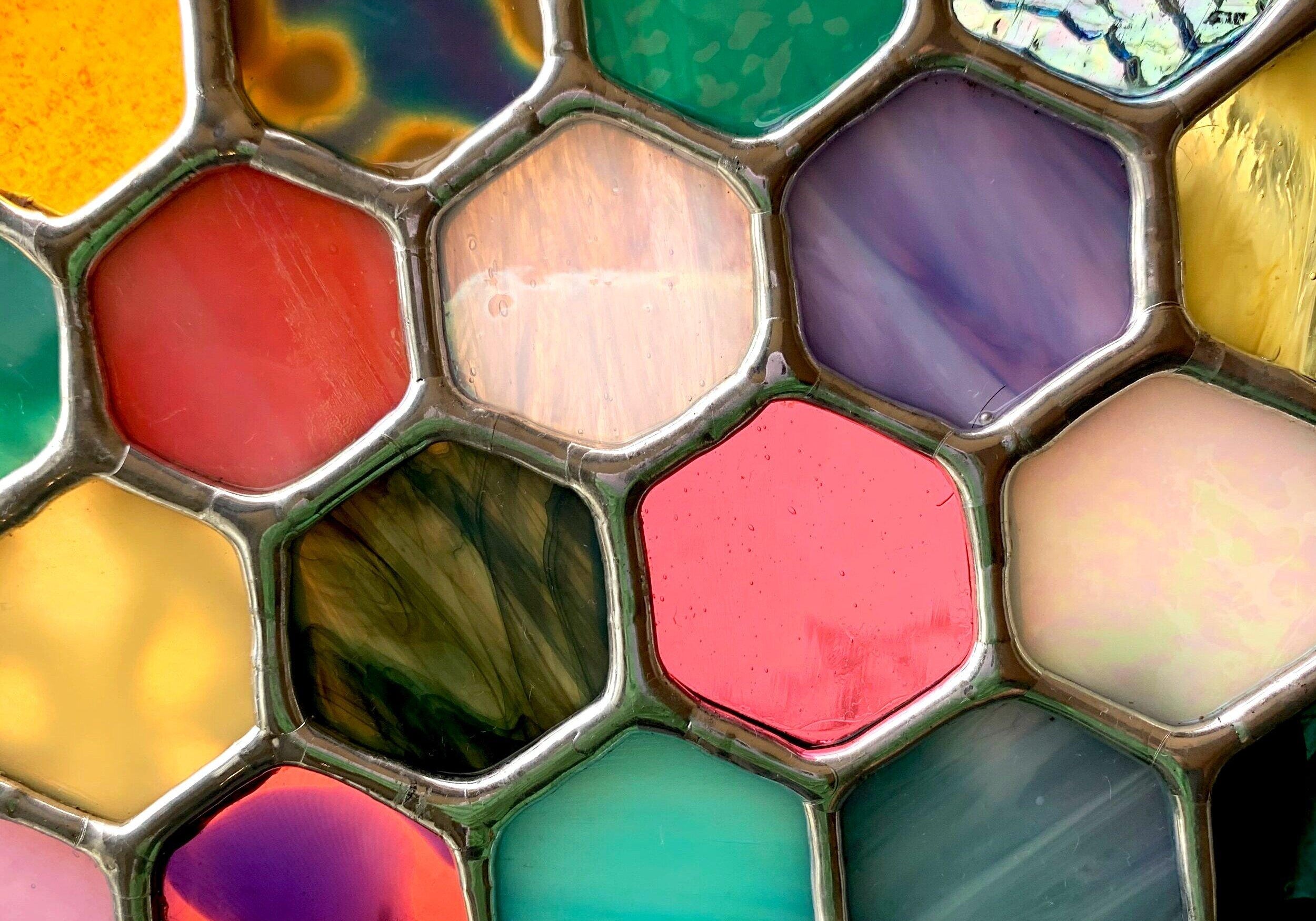 Stained glass hexagons with different colors and patterns coming together