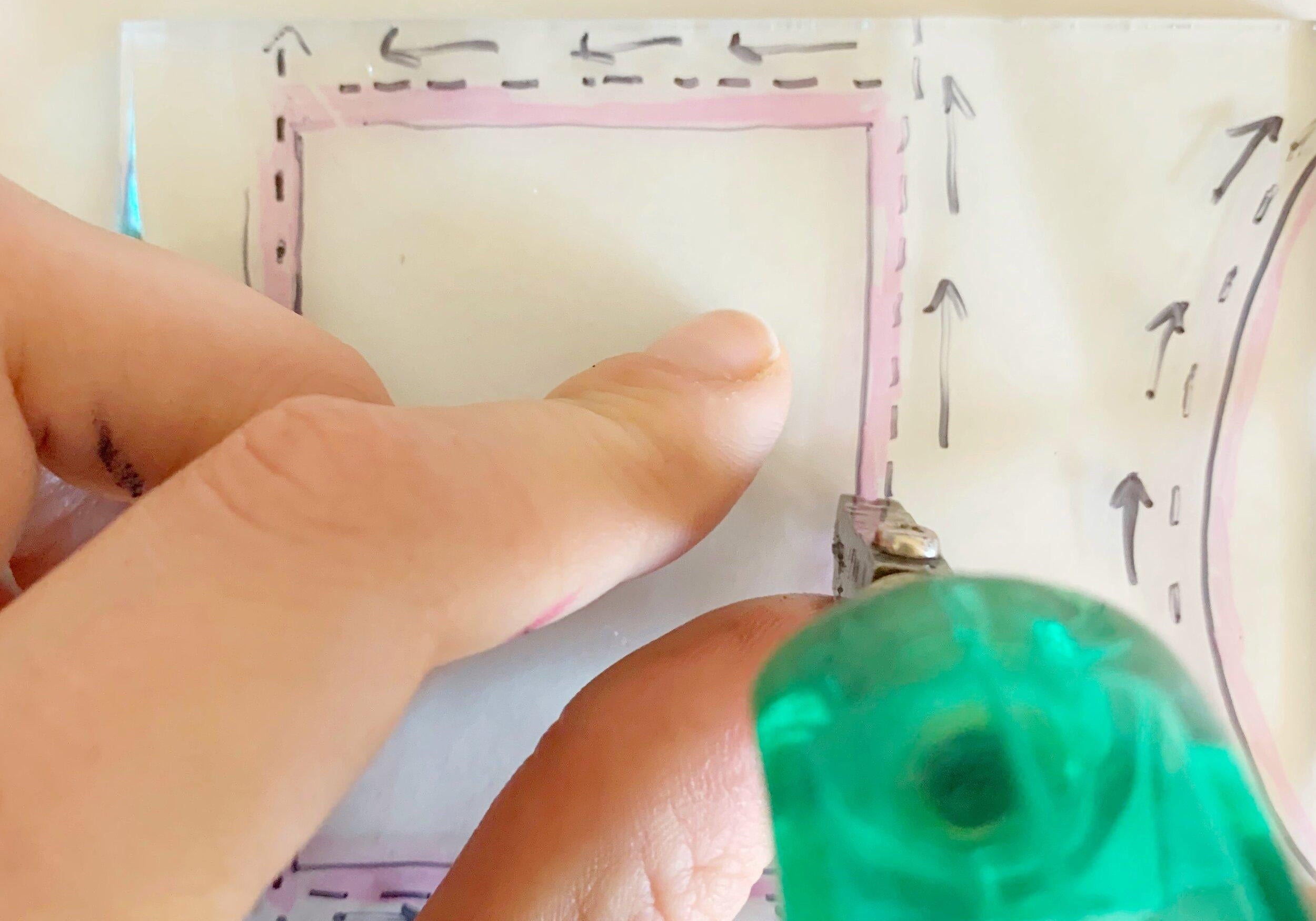 Image of someone cutting stained glass