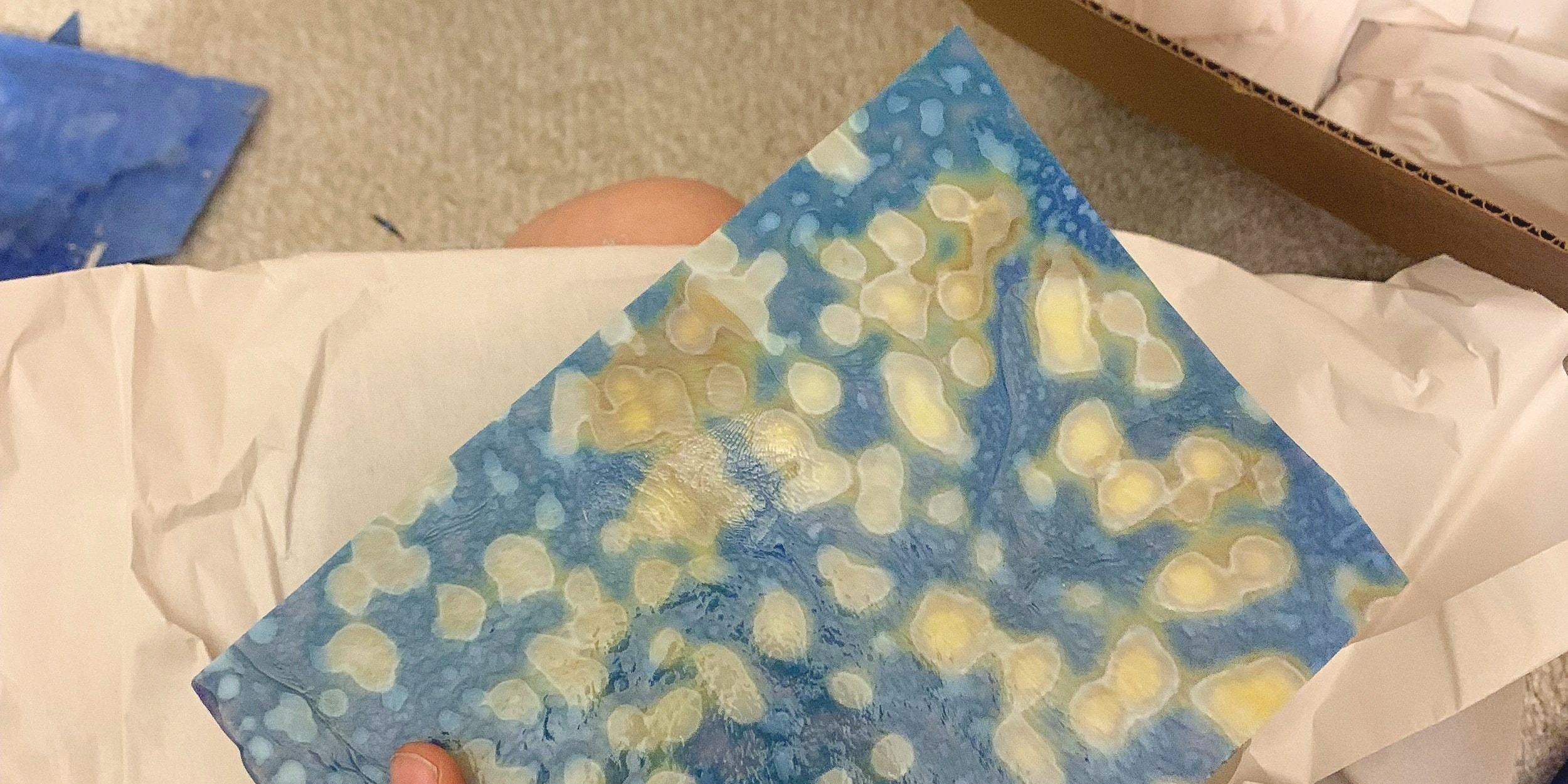 Image of someone packing stained glass for a move