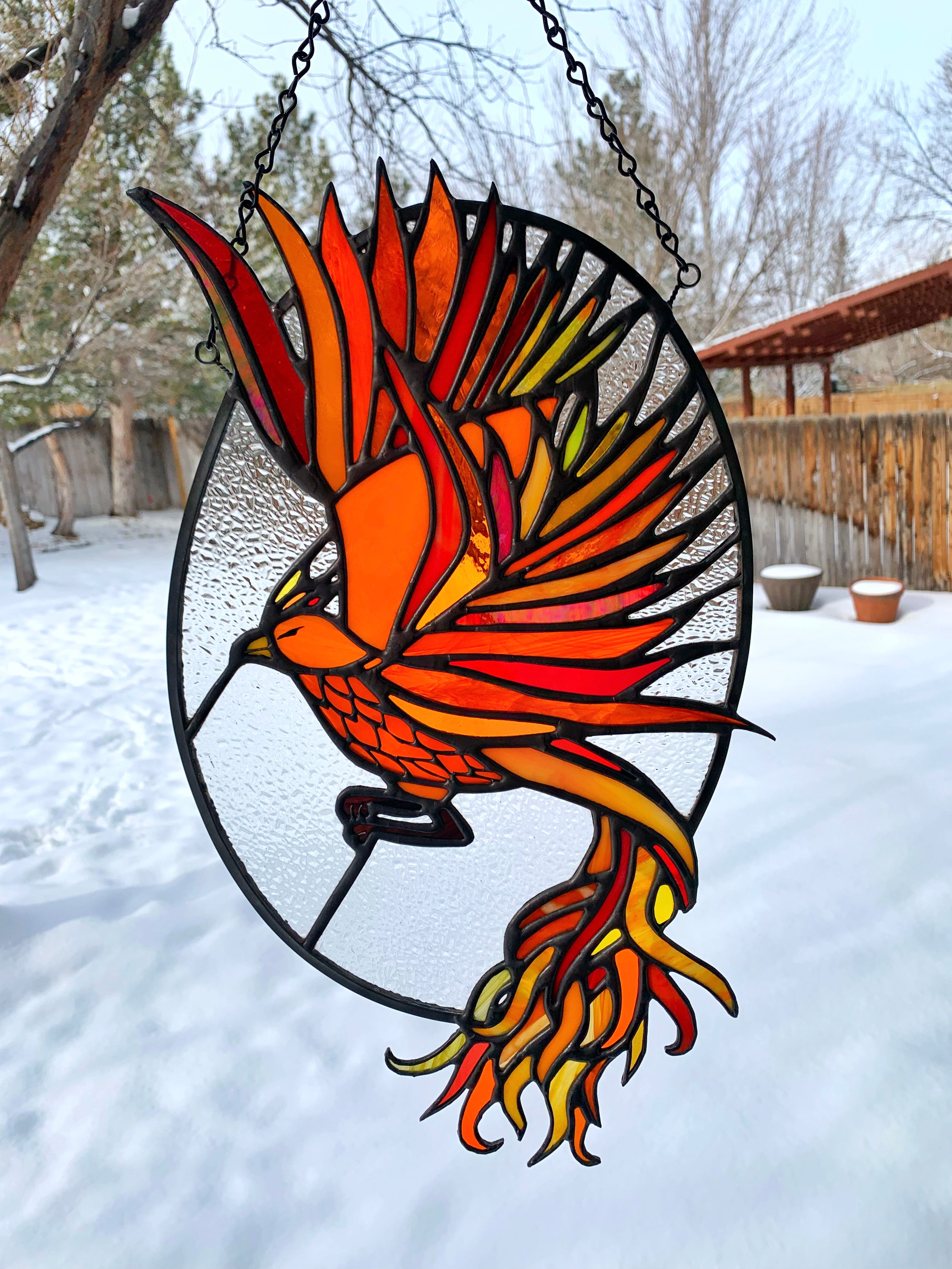 Stained glass firebird in an oval 