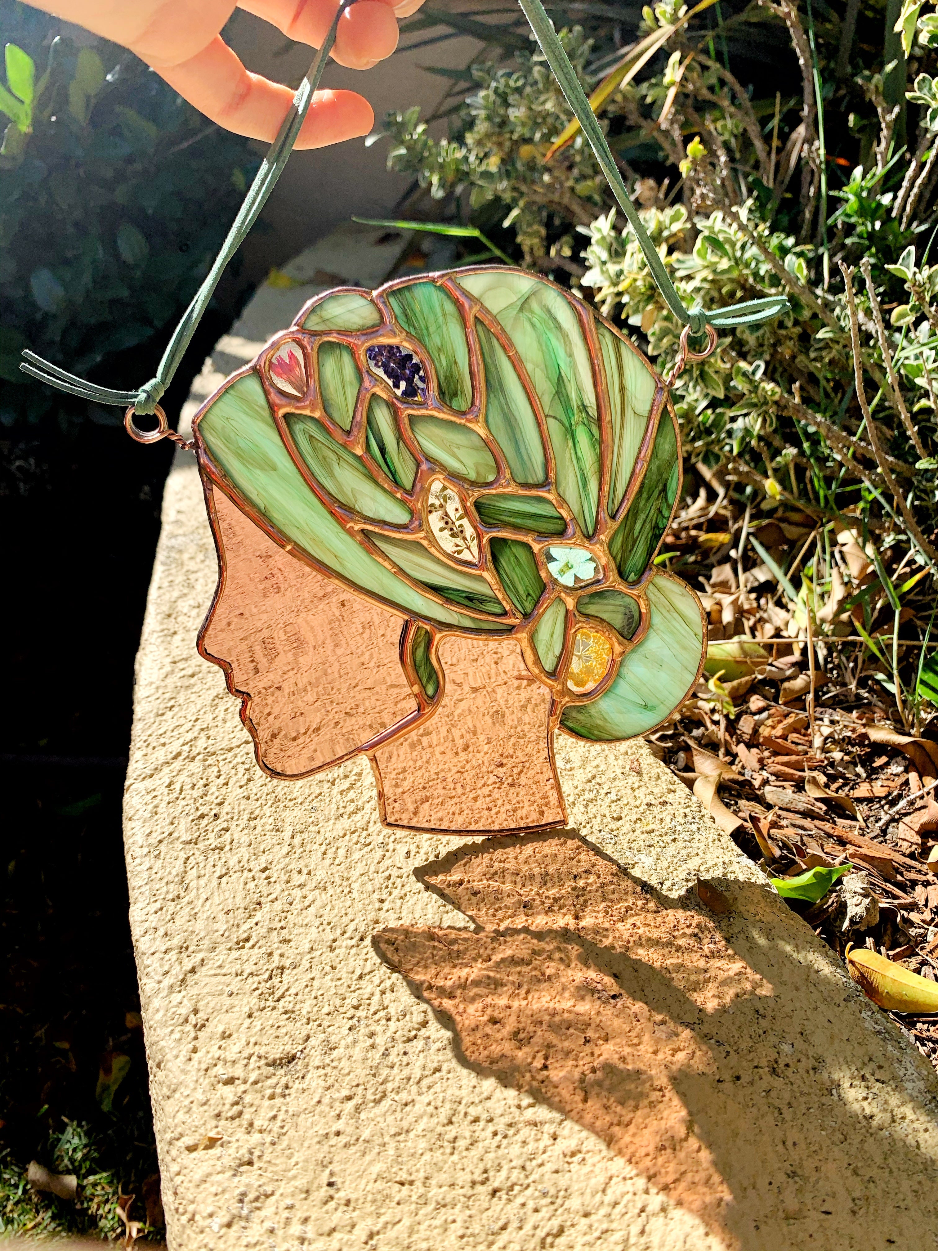 Stained glass woman with leaves in her hair
