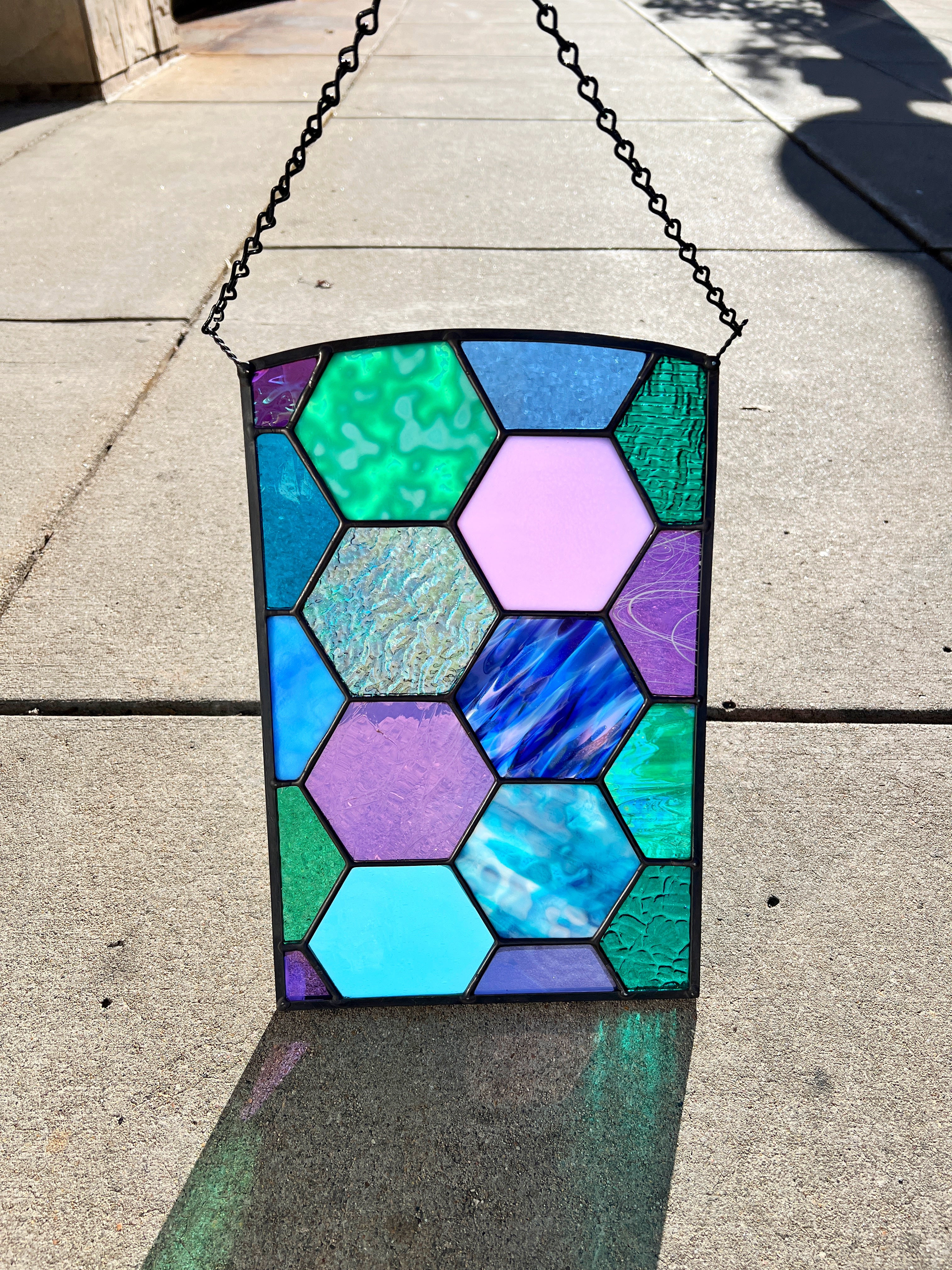 Stained Glass Panel made with purple, blue, teal glass in a hexagon design