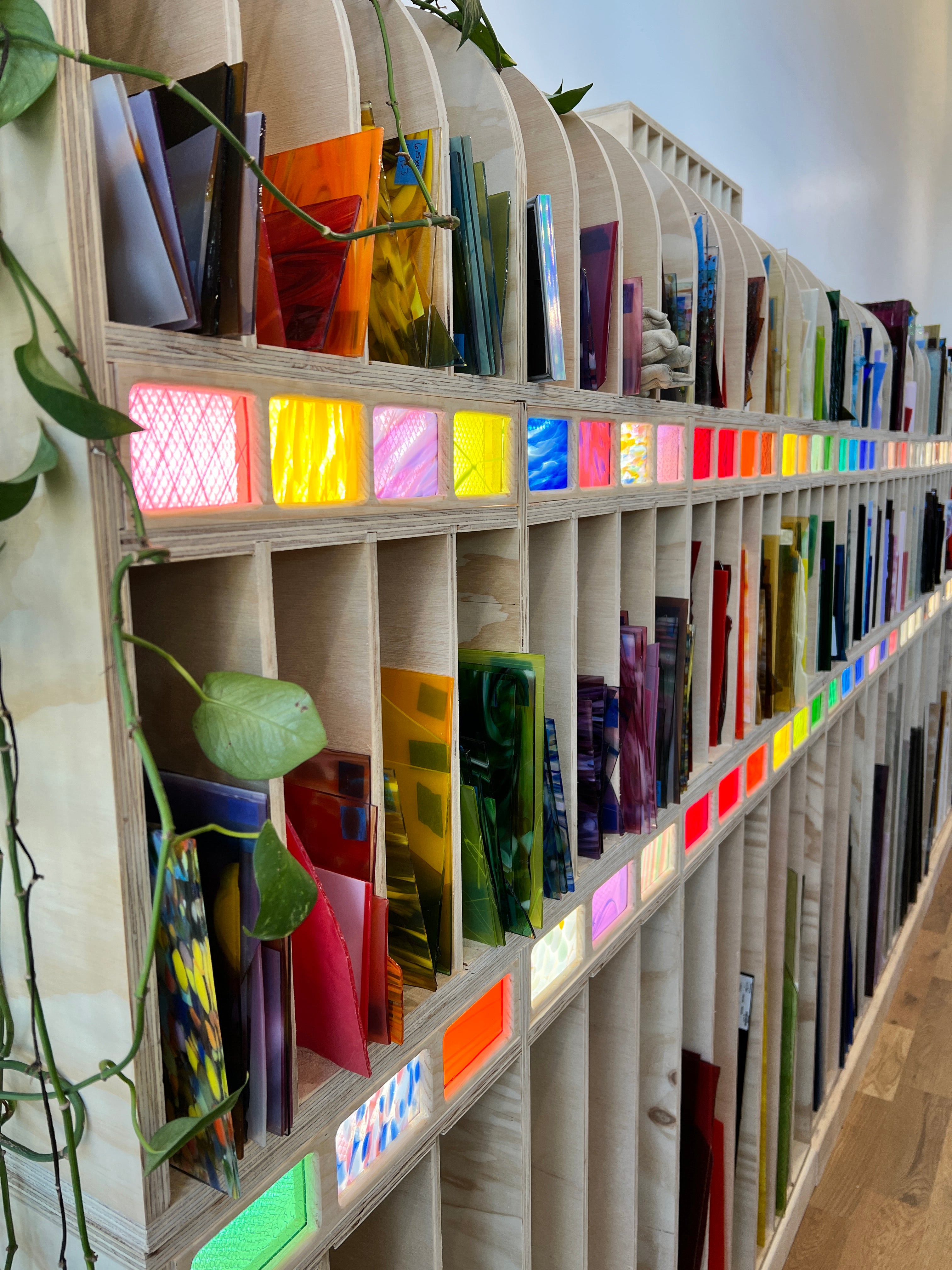 Picture is of a glass rack with multiple sheets of glass - showing a full view of the glass offerings in the studio