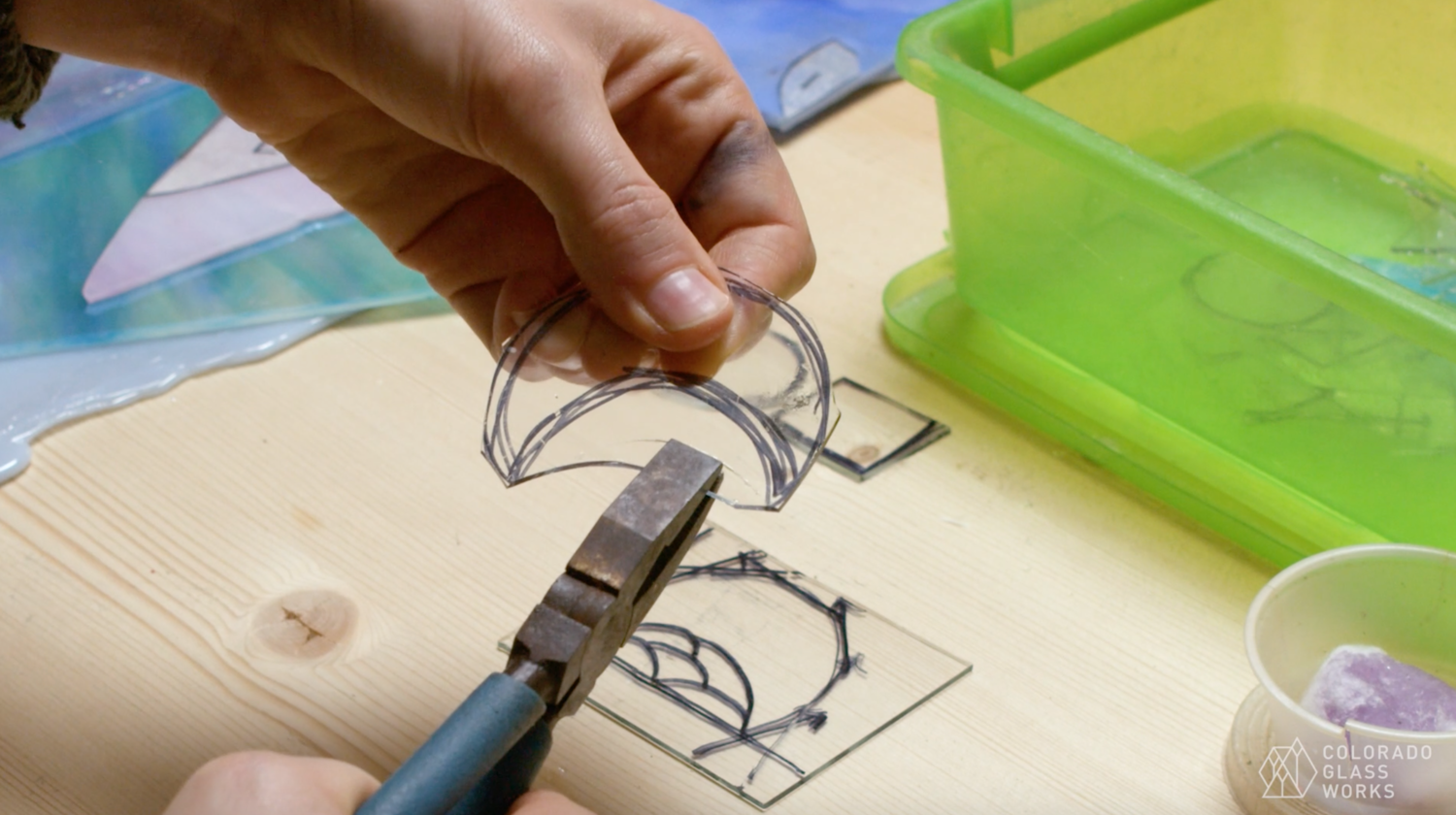 Photo of someone making a stained glass moon in the class